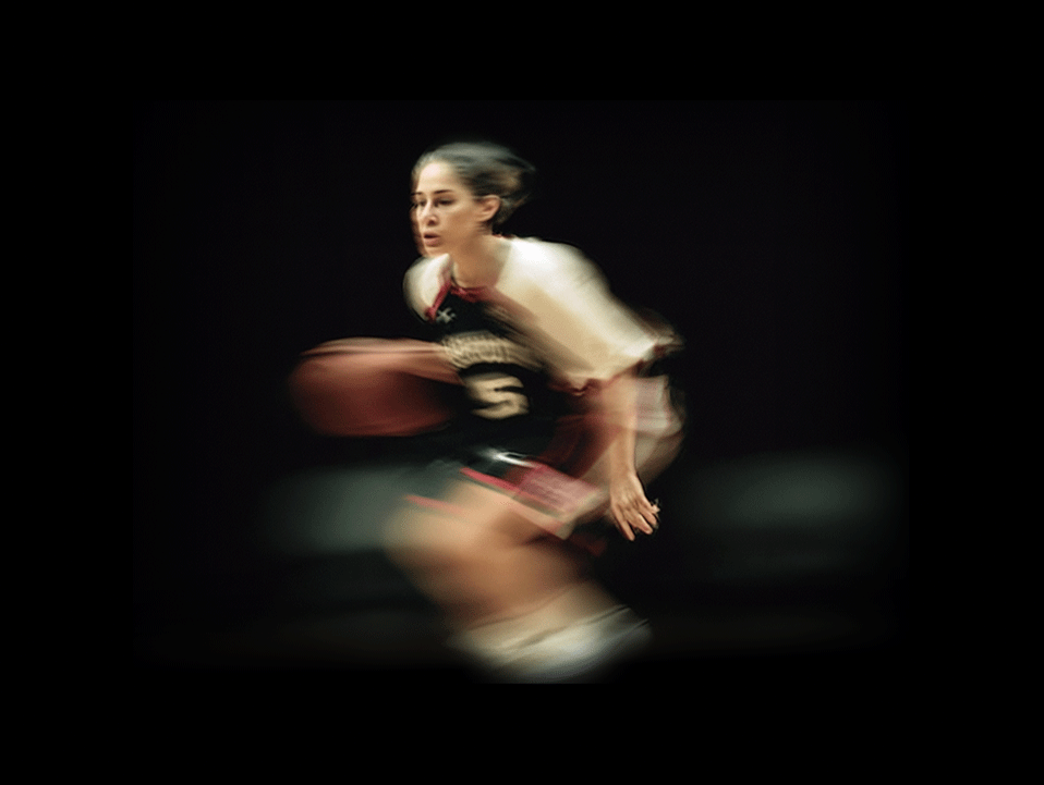 Basketball player dribbling in motion